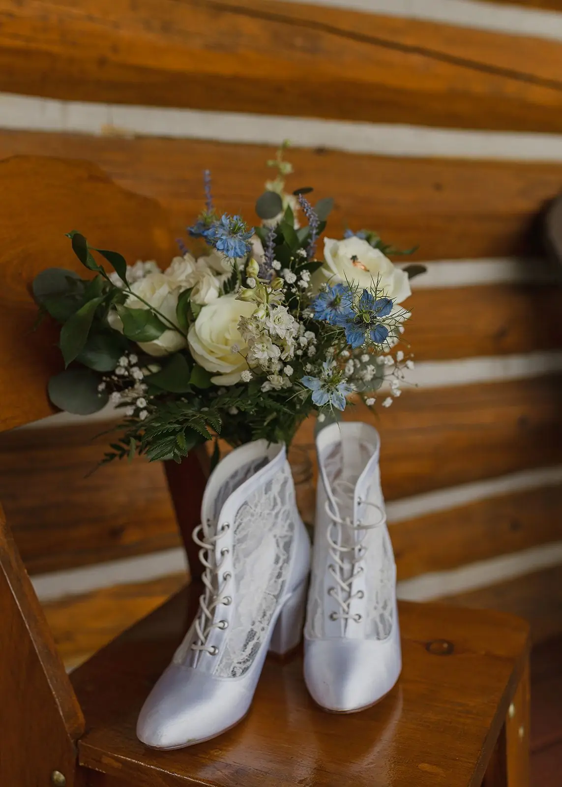 Wedding boots and a bouquet on a cabin table