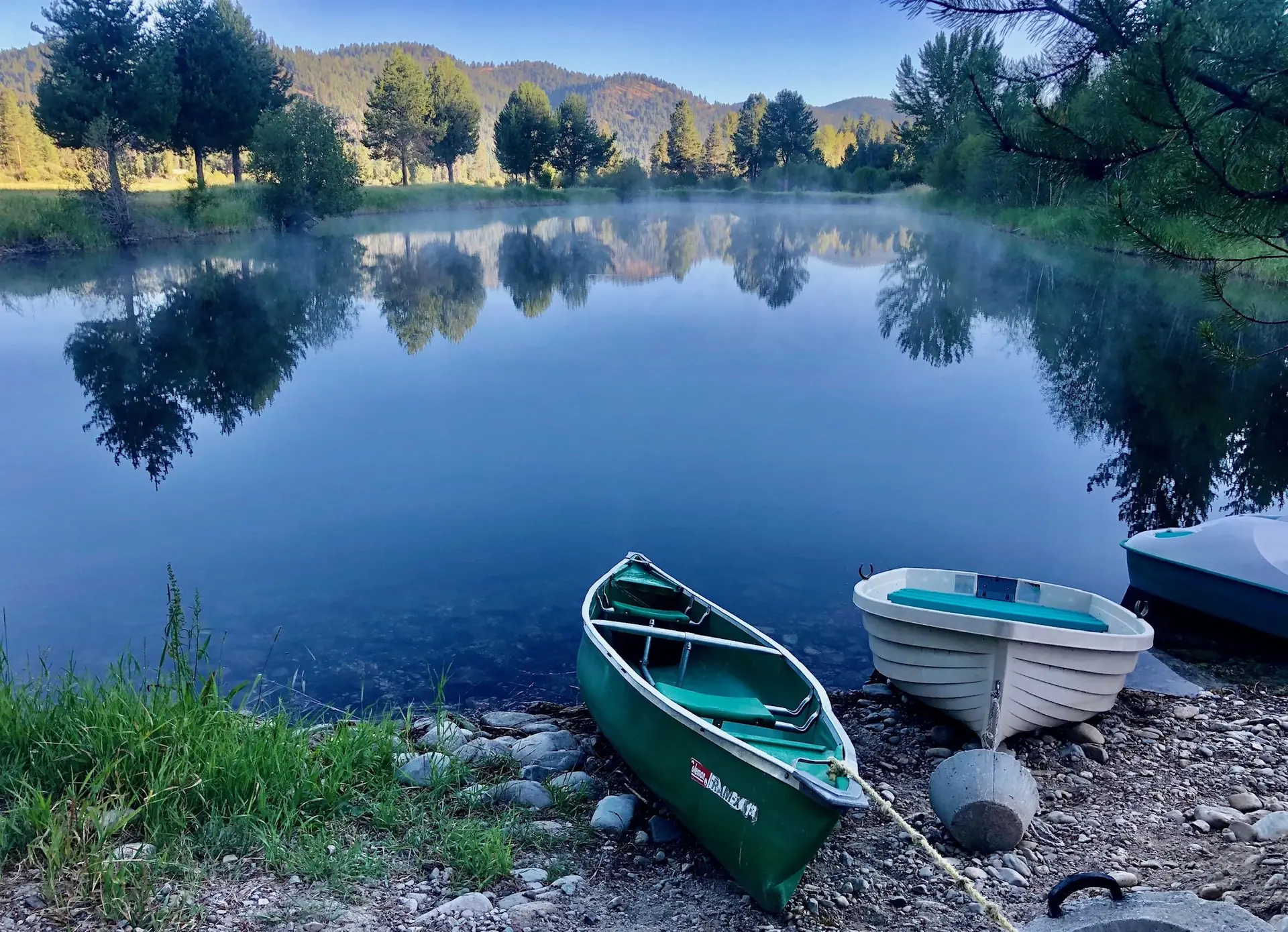 Canoes resting at the edge of the trout pond on Alta Ranch